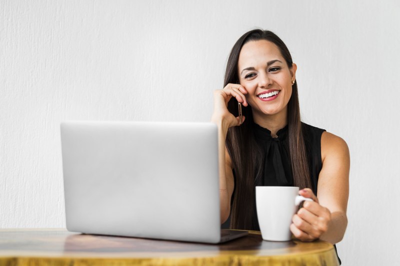 business-woman-with-cup-coffee-talking-phone
